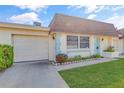 Attractive home with a garage, manicured lawn, and inviting curb appeal at 8457 Deauville # 8457, Pinellas Park, FL 33781