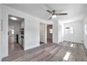 Well-lit living area featuring laminate flooring, a ceiling fan, a window, and fresh, white paint at 921 7Th Nw St, Largo, FL 33770