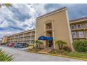 Low angle view of the condo building exterior showcasing multiple units and on-site parking at 1 Boca Ciega Point Blvd # 211, St Petersburg, FL 33708