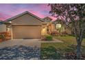 Charming single-story home with a well-manicured lawn and a two-car garage at 1010 Blue Heron Way, Tarpon Springs, FL 34689