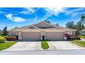 Exterior full frontal view of charming residences, each equipped with private two-car garages and convenient driveway parking at 1020 New Winsor Loop # 46, Sun City Center, FL 33573