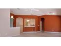 Open-concept living room with terra cotta-colored walls that connects the kitchen and features neutral carpet at 1020 New Winsor Loop # 46, Sun City Center, FL 33573
