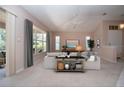 Bright living room featuring plush carpet, large windows with backyard views, and neutral paint at 1020 New Winsor Loop # 46, Sun City Center, FL 33573