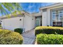 Well maintained exterior with two car garage and manicured shrubs lining the walkway to front door at 1034 Mcdaniel St # 1034, Sun City Center, FL 33573