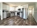 Modern kitchen featuring stainless steel appliances, white cabinetry, and stylish tile backsplash at 105 W Saint Johns Way, Apollo Beach, FL 33572