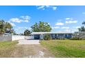 Inviting home with a metal roof, covered carport, and beautifully maintained front yard at 107 6Th Nw St, Ruskin, FL 33570