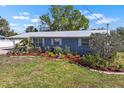 Landscaped front yard with vibrant plants and flowers enhances the curb appeal of this lovely home at 107 6Th Nw St, Ruskin, FL 33570