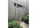 Exterior view showing a gated wooden fence in a shady area surrounded by greenery and foliage at 111 Woodland Pl, Osprey, FL 34229
