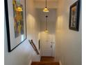 Hallway with Tiffany-style pendant lights and decorative wall art leading to the front door at 11450 Harbor Way # 5002, Largo, FL 33774