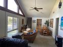 Bright living room featuring a vaulted ceiling, large windows, and stylish furnishings at 11450 Harbor Way # 5002, Largo, FL 33774