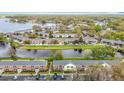 Aerial view of community with waterfront property, showcasing manicured lawns and brick-and-stucco exteriors at 13719 Juniper Blossom Dr, Tampa, FL 33618