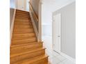 Wooden staircase with tile flooring, leading to a bright, open space and freshly painted walls at 13719 Juniper Blossom Dr, Tampa, FL 33618