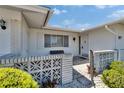 Inviting front porch featuring a decorative concrete wall, charming bench, and a well-maintained entrance at 1508 W Del Webb Blvd, Sun City Center, FL 33573