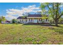 Inviting one-story home with a large front lawn and a cozy covered porch at 15124 Appaloosa Hills Dr, Dade City, FL 33523