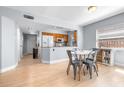 Bright dining area with wood floors and an adjacent kitchen at 16858 Le Clare Shores Dr, Tampa, FL 33624