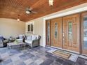 Welcoming covered porch with double doors, stylish slate flooring, and comfortable seating at 2823 St Croix Dr, Clearwater, FL 33759