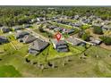 Aerial view of a home in a residential neighborhood with well-maintained lawns and mature trees at 3020 Silva Wood Dr, Valrico, FL 33596