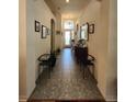 Bright hallway featuring tile flooring, archways, decorative lighting, and elegant decor at 3215 Coconut Grove Rd, Land O Lakes, FL 34639