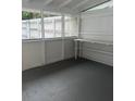 This enclosed porch is well lit and can be used for storage or recreation at 38030 Howard Ave, Dade City, FL 33525