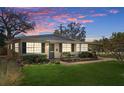 Charming single-story home with a well-manicured lawn and lush landscaping at 4630 W Bay Villa Ave, Tampa, FL 33611