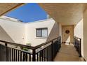Exterior building shot showcasing walkway, and front door with accent wreath under a sunny sky at 5729 Puerta Del Sol Boulevard South # 486, St Petersburg, FL 33715