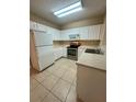 Well-equipped kitchen with tile flooring, stainless steel appliances and white cabinetry at 6002 Osprey Lake Cir, Riverview, FL 33578