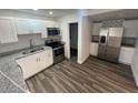 Modern kitchen features stainless steel appliances, granite countertops, and white cabinets at 645 38Th S Ave, St Petersburg, FL 33705