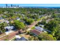 An aerial view of a neighborhood with mature trees and the city skyline in the distance at 860 17Th S Ave, St Petersburg, FL 33701
