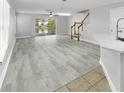 Bright open-plan living room with modern floors, a ceiling fan and natural light at 10906 Johanna Ave, Riverview, FL 33578
