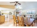 Bright dining area features wood floors, fireplace, and views to the open kitchen at 1232 Persimmon Dr, Holiday, FL 34691