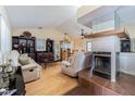 Cozy living room with hardwood floors, a fireplace, and ample seating at 1232 Persimmon Dr, Holiday, FL 34691