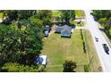 Expansive property featuring a well-maintained home, outbuildings, and a large, grassy yard at 1413 Lithia Pinecrest Rd, Brandon, FL 33511