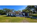 Inviting single-story home featuring a well-maintained lawn and classic design at 1413 Lithia Pinecrest Rd, Brandon, FL 33511