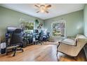 Bright, airy room featuring hardwood floors, two windows, ceiling fan and a couch at 1905 Dove Field Pl, Brandon, FL 33510