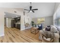 Open-concept living area with vaulted ceiling, hardwood floors, and ample natural light at 1941 48Th S St, St Petersburg, FL 33711