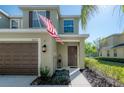Inviting home exterior showcasing a manicured lawn and a welcoming entrance with a charming covered porch at 20319 Starfinder Way, Tampa, FL 33647