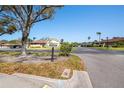 A serene Laurelwood Condominium community entrance featuring lush landscaping and well-maintained surroundings at 2260 Oak Neck Rd # B, Clearwater, FL 33763