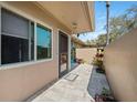 Charming condo entrance with stone pavers, a secure screen door, and well-tended potted plants at 2260 Oak Neck Rd # B, Clearwater, FL 33763