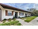 Charming exterior view of the home with well-maintained landscaping and inviting entrance at 2448 Enterprise Rd # 5, Clearwater, FL 33763