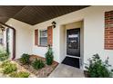 Close up of front entrance featuring a black front door and brick accents at 2448 Enterprise Rd # 5, Clearwater, FL 33763