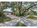 Beautiful home with a large tree in the front yard and a two-car garage, creating a picturesque setting at 325 Orangeview Ave, Clearwater, FL 33755