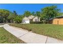 Inviting single-story home with lush front lawn, mature trees and attached two-car garage at 408 Valencia Park Dr, Seffner, FL 33584