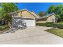 Attached two-car garage with a spacious driveway and well-maintained landscaping at 408 Valencia Park Dr, Seffner, FL 33584