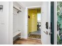 A welcoming foyer featuring a bench, coat rack, stylish decor, and view of a balcony creating an inviting entryway at 455 Alt 19 S # 162, Palm Harbor, FL 34683