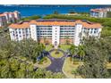 Aerial view of a building with a red tile roof surrounded by lush landscaping and palm trees at 4801 Osprey S Dr # 404, St Petersburg, FL 33711