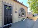 Charming front porch featuring an arched window, a black door and the house number 5807 at 5807 N Miami Pl, Tampa, FL 33604