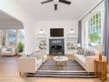 Bright, airy living room featuring modern furniture, a decorative fireplace, and ample natural light at 5807 N Miami Pl, Tampa, FL 33604