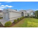 A charming home with a well-manicured lawn and an attached two-car garage at 9339 Creole Ct, Weeki Wachee, FL 34613