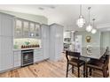 Spacious kitchen featuring custom cabinets, a wine fridge, a large island, and wood floors at 9466 127Th Ave, Largo, FL 33773
