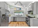 Bright kitchen features updated cabinets, countertops, stainless steel appliances, and stylish window treatments at 9466 127Th Ave, Largo, FL 33773